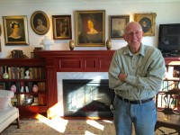 Jan Efraimsen of Woodtronics Millwork Corp. stands in front of the mantel and bookcases his company designed and constructed to best utilize space and bring definition to a room.