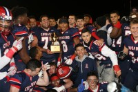 Tigers Captains Khaleb Celaj and Terrell Morrison (center) hold the Michael Cunnion Memorial Trophy, as the Crusaders celebrate winning the 2015 CHSFL AAA Championship, at Fordham University on Saturday, Nov.21. Albert Coqueran Photo 