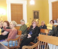 Seniors and other supporters of a senior center at Butterfield held up signs encouraging legislators to vote yes on the project.