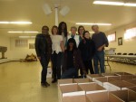 Volunteers from Foster Kids Unite, including its founder Tanya Cooper, kneeling in front, pack holiday gift boxes for youngsters last Saturday.