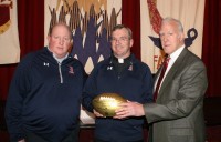 Bob Hyland (right), a member of the 1968 Super Bowl II Champion Green Bay Packers, presents an NFL Wilson Gold Football to his alma mater Stepinac High School. Stepinac President Father Thomas Collins (center) and Athletic Director Mike O’Donnell (left) accept the distinction, which symbolizes Stepinac’s participation in the NFL Super Bowl High School Honor Roll Initiative. Albert Coqueran Photo