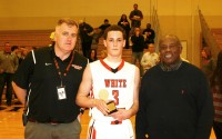The Harry Jefferson Showcase Sportsmanship Award for the White Plains vs. Harrison game was presented to Tigers guard Jace Yaverbaum, by WPHS Athletic Director Matt Cameron (left) and tournament namesake Harry Jefferson. Yaverbaum (center) had 13 points in the game with nine points coming in the fourth quarter on three three-point shots. 