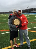 Stepinac Associated Head Coach/Offensive Coordinator Joe Spagnolo (left) and Defensive Coordinator Jonathan Demarco share a moment with the CHSAA NYS Championship Plaque. Photo courtesy of Jonathan Demarco
