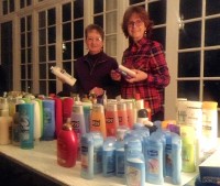 (L to r) Sue Lynn and Claudia Melo of the Woman’s Club line up items prior to packaging and delivery to My Sisters Place.