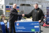 Clean Well not only distributed trademark Hand Wipes and Sanitary Hand Cleanser at the NY Rangers and Chase Youth Hockey Equipment Drive, but on behalf of the Clean Well organization, Rangers Adam Graves (left) presented a check for 00 to White Plains Recreation Supervisor Matt Hanson (right) to help rink programs at Ebersole. White Plains Recreation & Parks Commissioner Wayne Bass also participated in the check presentation. 