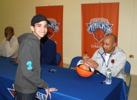 Chris Peralta (left) a 12 year-old student at Sleepy Hollow Middle School, in Tarrytown, is all smiles as he gets his basketball autographed by NY Knicks legend John Starks, during a Meet-and-Greet before the Westchester Knicks played their first-ever Playoff Game at the Westchester County Center. Other NY Knicks alumni participating in the autograph session were: Larry Johnson, Herb Williams, Vin Baker and John Wallace. Albert Coqueran Photos