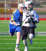 Mahopac long stick middie Aidan Hynes (L) and the Indians could not match the firepower of Yorktown sophomore Jamison Embry (R) and the Huskers last Tuesday when Yorktown defeated Mahopac.