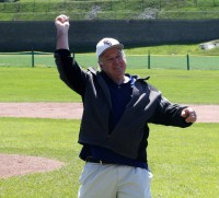 : Joe McAvoy, who was the Head Baseball Coach at WPHS for two intervals totaling 19 years, throws out the ceremonial first pitch to commence the Joe McAvoy City Challenge, at White Plains High School, on Saturday. 