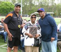 Glenn D. Loucks Games Meet Director Fred Singleton (left) presents a plaque to Martha James (center) and Larry James, Jr., the mother and son of the late famed White Plains High School track star Larry James (’66), who passed away in November 2008. James, also a Gold Medal Olympian and his three relay team members were honored at this year’s Loucks Games. James, Dave Jackson, Carl Reed and Otis Hill famed Tigers 1966 Relay Team set New York State high school records in the 880 and Mile Relay, which remain standing today. 