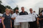 State Sen. Terrence Murphy presented Mount Pleasant Supervisor Carl Fulgenzi with a check for 0,000 for downtown improvements during the Aug. 21 Mount Pleasant Day celebration.