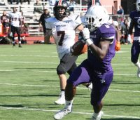 Huguenots running back Jordan Forrest (right) was a lot to handle for the Tigers defense. He scored two touchdowns and kicked six extra points in the New Rochelle win over White Plains, 42-6. 