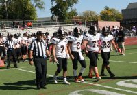 Tigers’ Team Captains [l-r] seniors Ferdinando Spista, Chris Schiavone, Andrew Sandberg and Angel Rivera walk out in unison for the coin toss to start the Section 1 AA Playoff Game against the Huguenots.