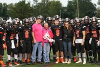 The White Plains football team commemorated the kickoff of Breast Cancer Awareness Month by honoring Nancy Heffernan (with flowers), the mother of wide receiver Dennis Heffernan (right #9) in a pregame ceremony on Friday. Nancy’s husband Kevin (left), a member of the WPFD and her daughter Gabby (right) also attended the event. Albert Coqueran Photos 