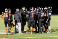 White Plains first year Head Coach Mike Lindberg (center) tries to rally the Tigers in the third quarter but Port Chester proved too much.