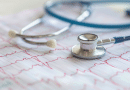 apple health scale - photo of a stethoscope on top of an ekg printout