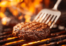 grill spatula- photo of a burger being flipped with a bbq spatula