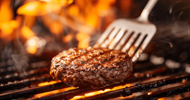 grill spatula- photo of a burger being flipped with a bbq spatula