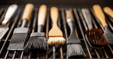 BBQ basting brush - photo of several different kinds of basting brushes laying on a bbq grill