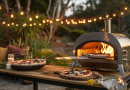 Compact backyard pizza oven in use, cooking a pizza with melted cheese and crispy crust on a cozy patio, ideal for outdoor dining.