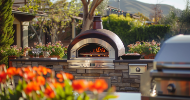 pizza oven buyers guide - photo of a beautiful backyard with red flowers and a pizza oven in the background next to a grill