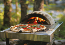 mastering outdoor pizza ovens - photo of a pizza just removed from an outdoor oven