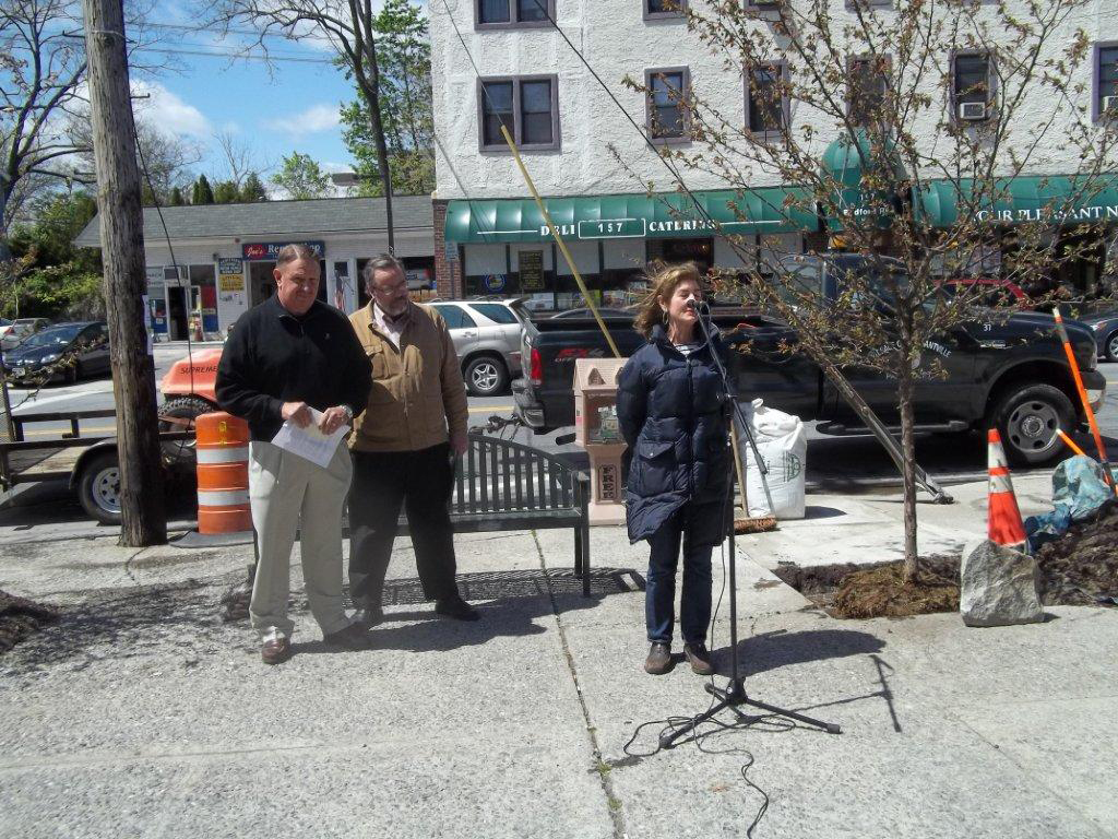 Pleasantville Beautification Chairwoman Kathy Dinkel salutes retired DPW Superintendent Stephen Johnson on Arbor Day for his work with the village's trees by dedicating a tree last Friday in his name on Bedford Road.