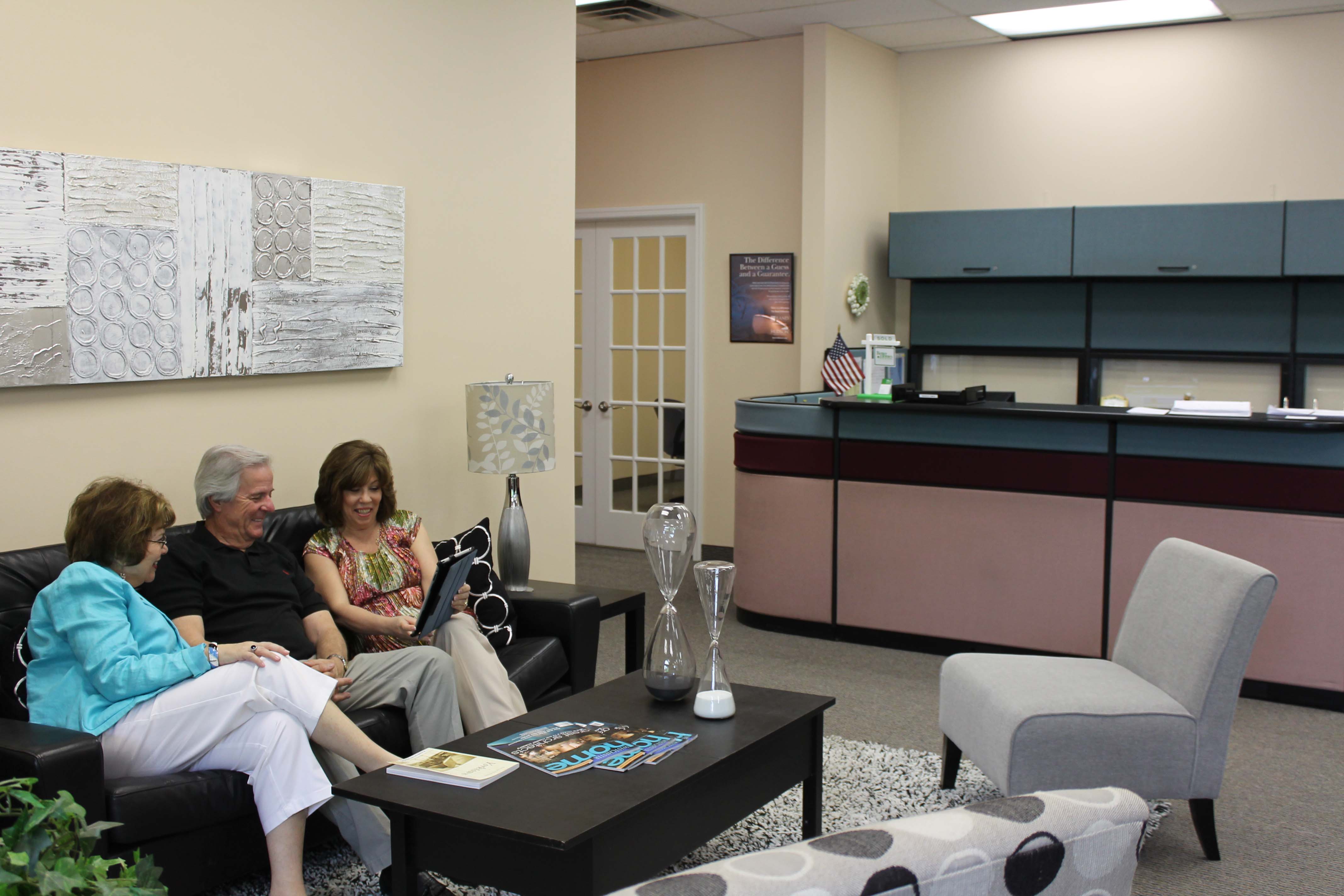 Diane and Bob Arenholz with Susan Labate in the lounge area of the new office in Yorktown.