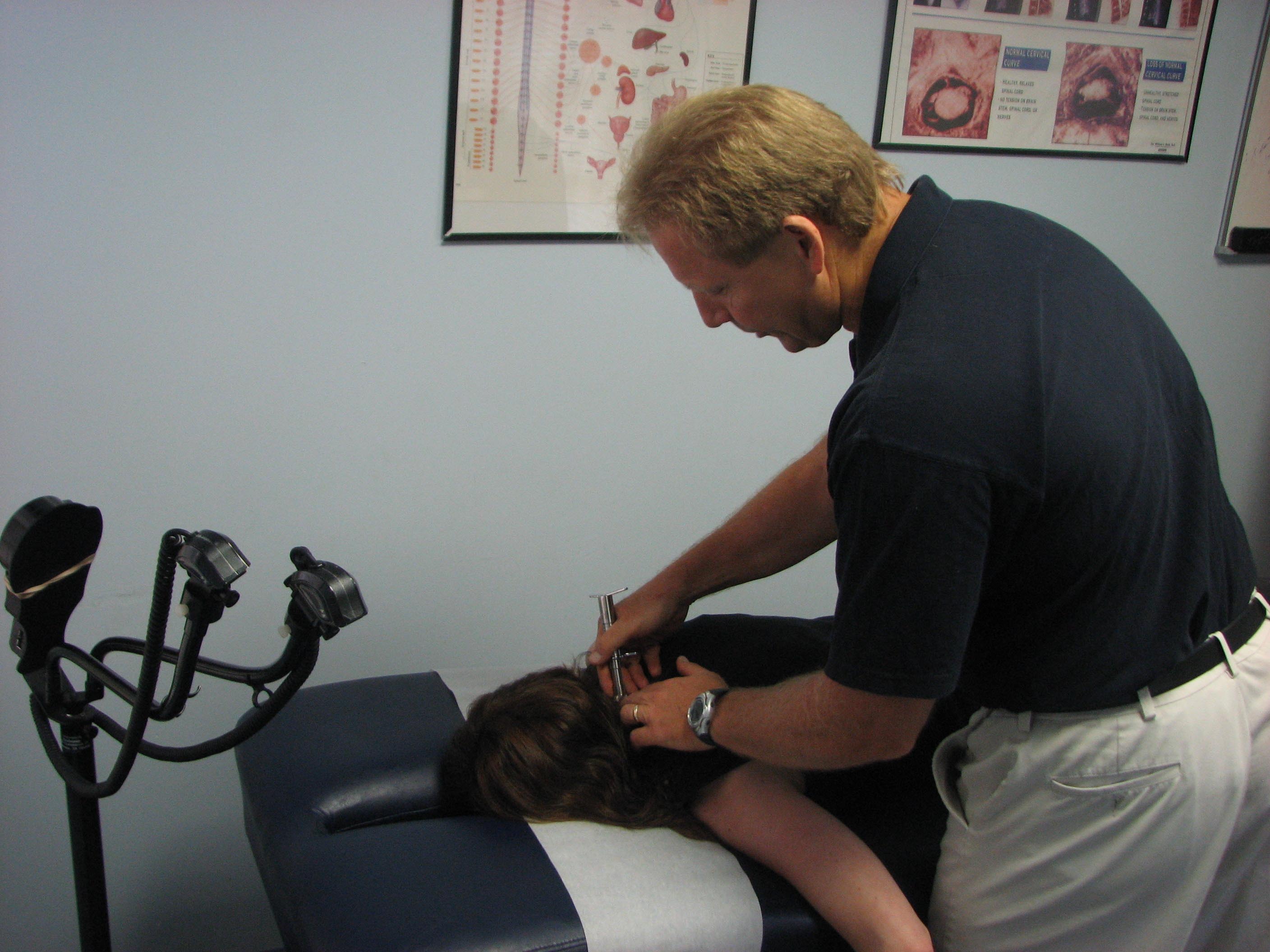 Dr. Paul Kastuk demonstrates the gentle chiropractic technique he uses that he said defies the misheld belief that chiropractors “crack backs.”