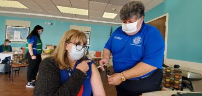 Michael Nesheiwat, MD, Putnam County Commissioner of Health administers a Moderna COVID-19 vaccination 