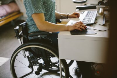 Person in wheelchair using the computer