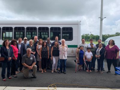 Individuals standing with bus 