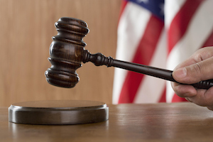 Close up of a gavel held in a person's hand