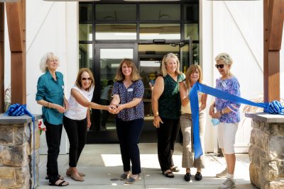 Individuals at a ribbon cutting ceremony