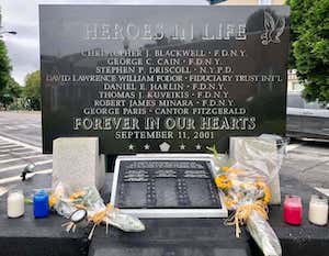 9/11 memorial with flowers and candles