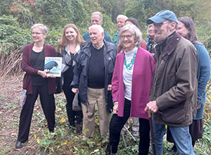 Twig George, daughter of the late acclaimed children’s author Jean Craighead George, center, picture with her brothers, illustrator Wendell Minor, right and New Castle Town Historian Gray Williams, among other community members, celebrate the dedication of the new park named in George’s honor.