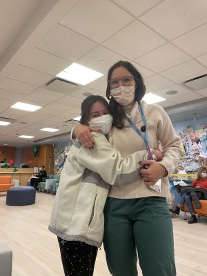 Natalie with a staff member at Memorial Sloan Kettering. After so many hospital visits, Natalie says the medical staff has become like family. (Photo courtesy of Natalie Ballin)