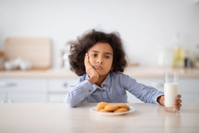 unhappy kid eating